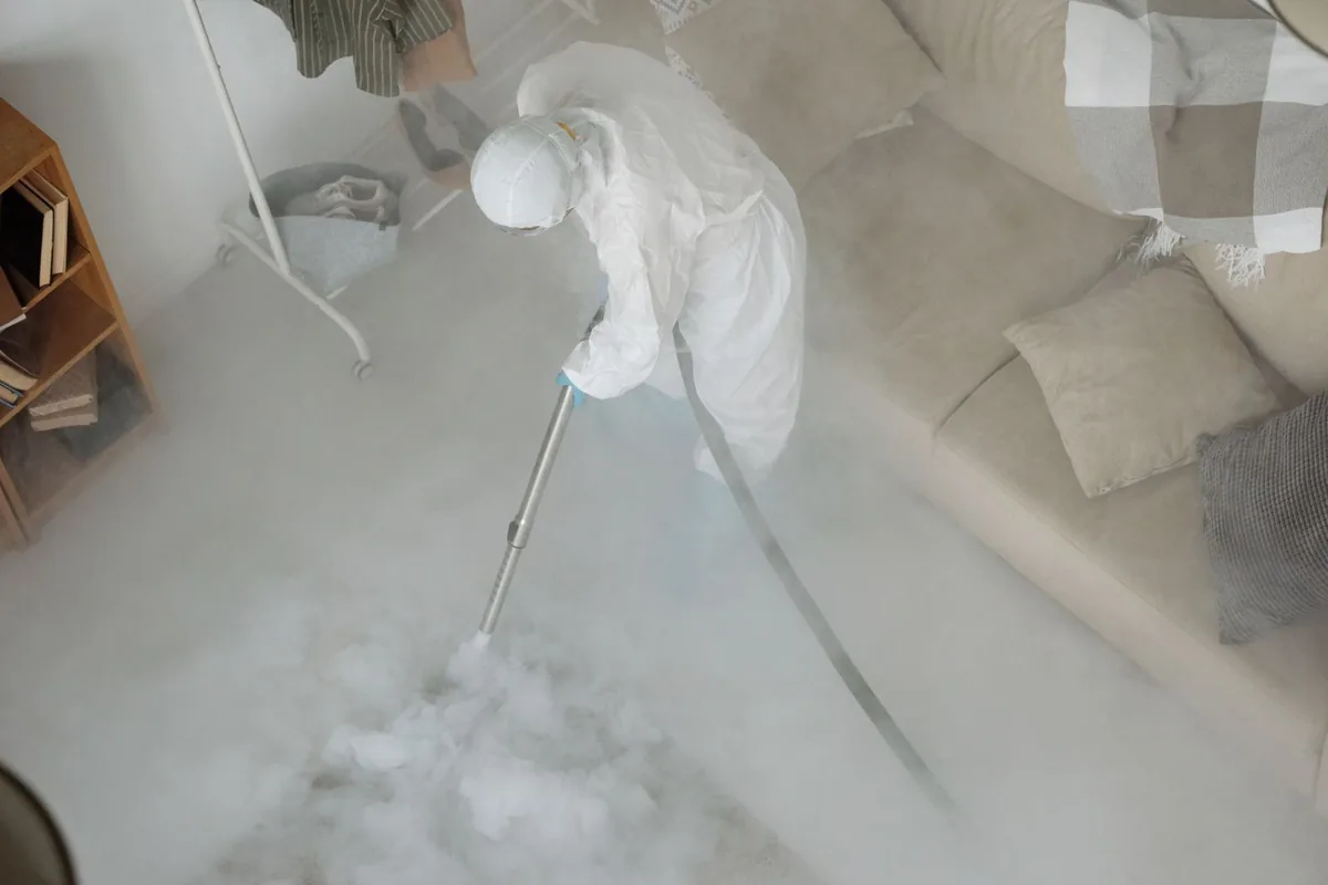 Biohazard cleanup technician in protective equipment, Ruidoso Downs, NM